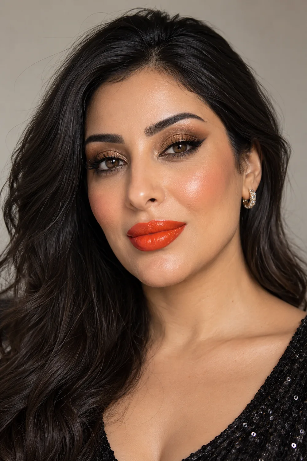 Fictional adult woman with bronze smoky lids, a thin espresso flick, warm apricot blush and vivid tangerine satin lipstick.