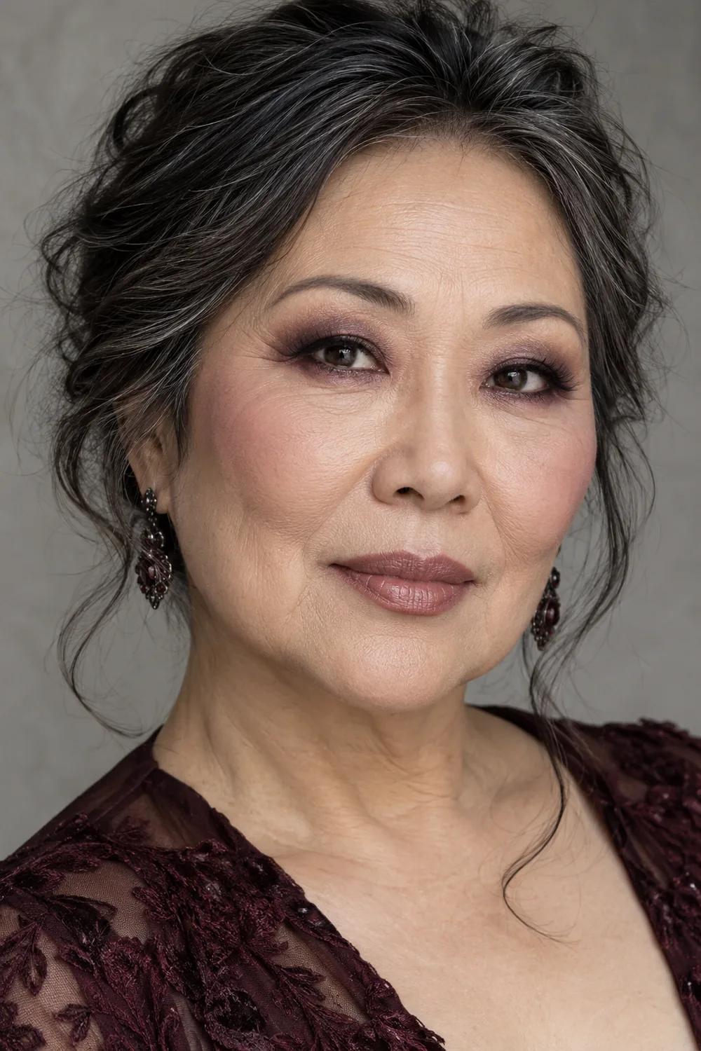 Photorealistic portrait of a mature East Asian woman wearing smoky taupe eye shadow, plum lower lash line, rounded charcoal liner, mauve blush, and nude-rose lipstick.