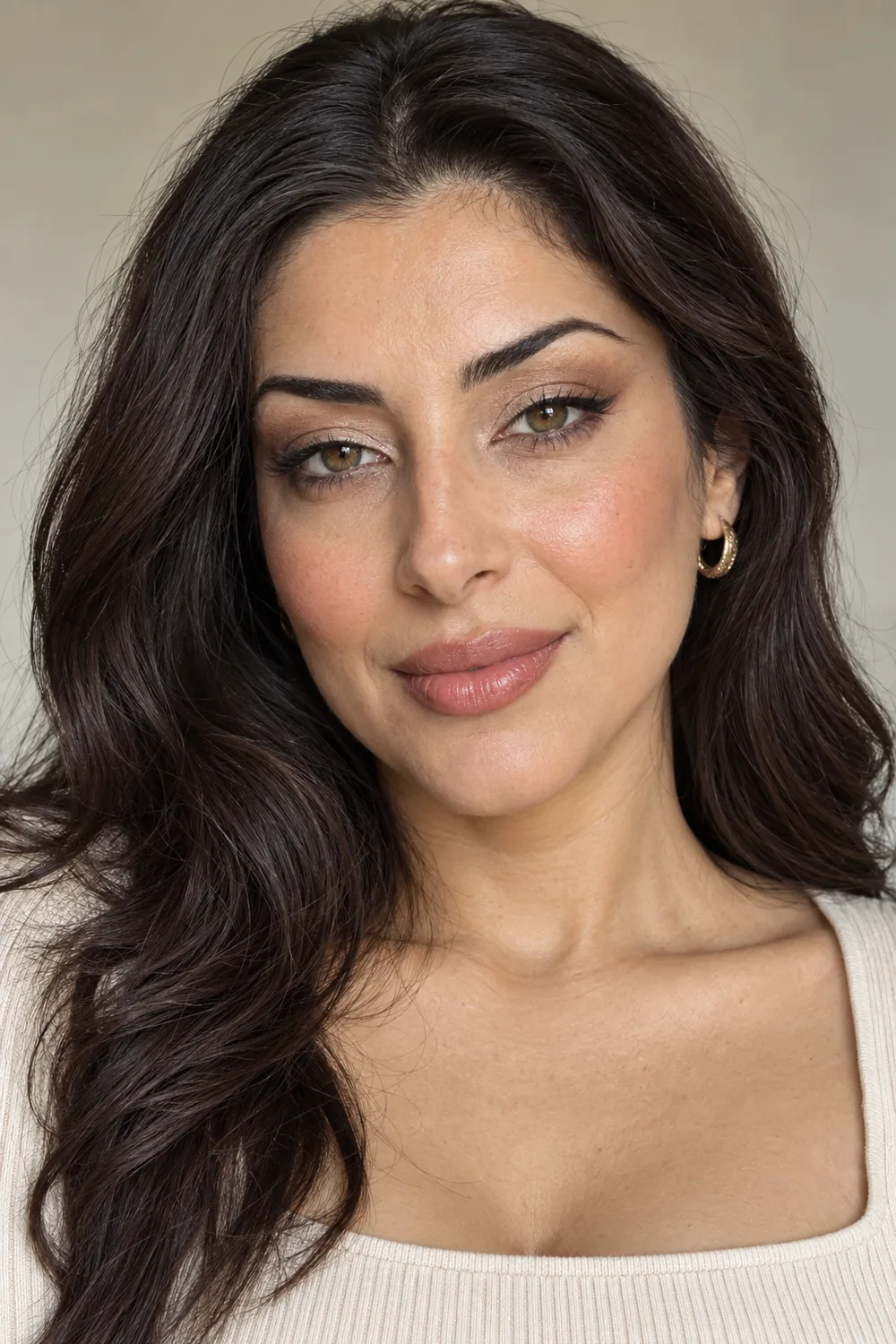 Fictional adult Middle Eastern woman with open hooded hazel eyes, champagne lid shimmer, brown outer shadow and liner flick, peach blush, and rose-beige lipstick.