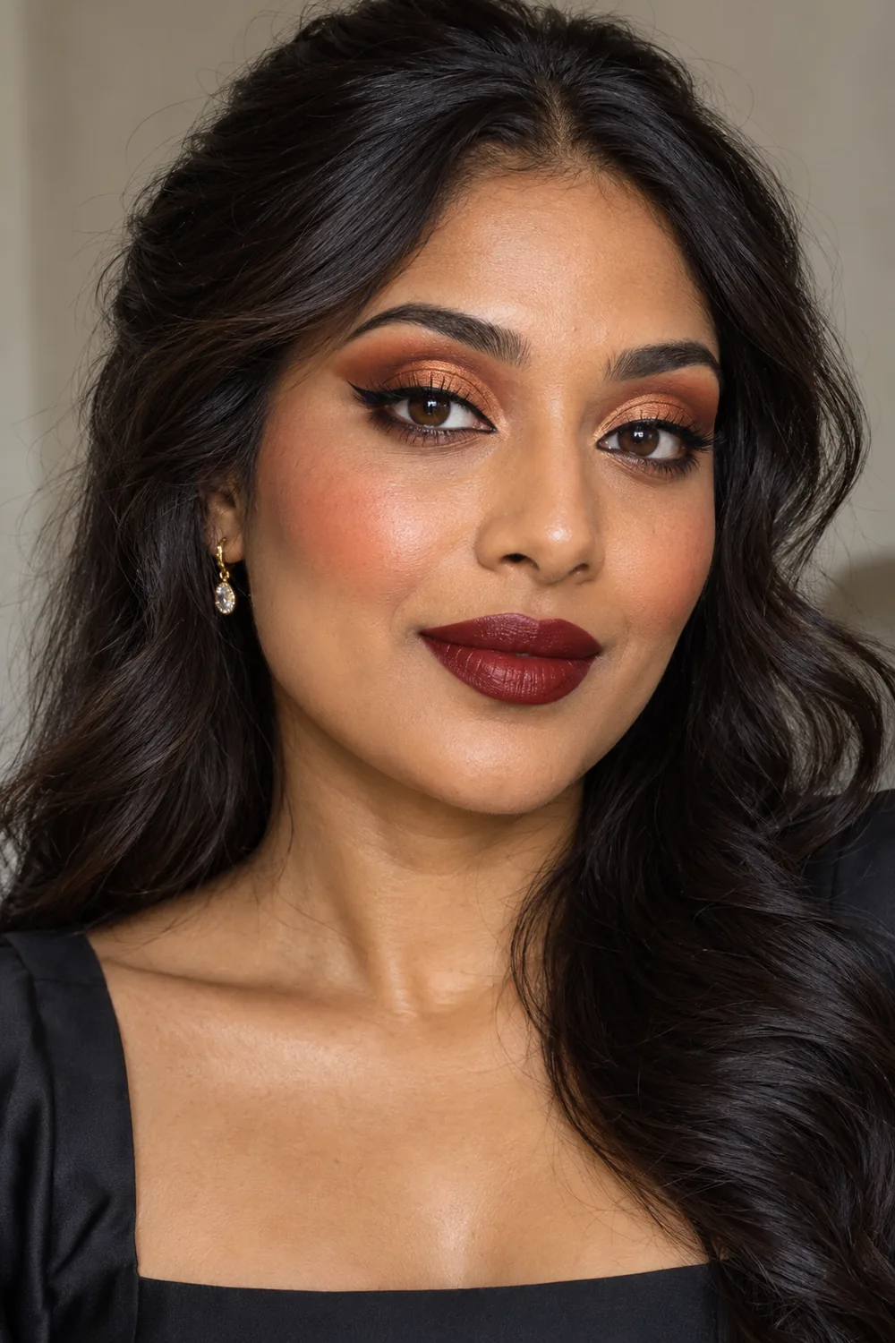 Adult woman with copper cut crease, rust transition shadow, lifted black liner, brick blush, and deep wine lipstick.