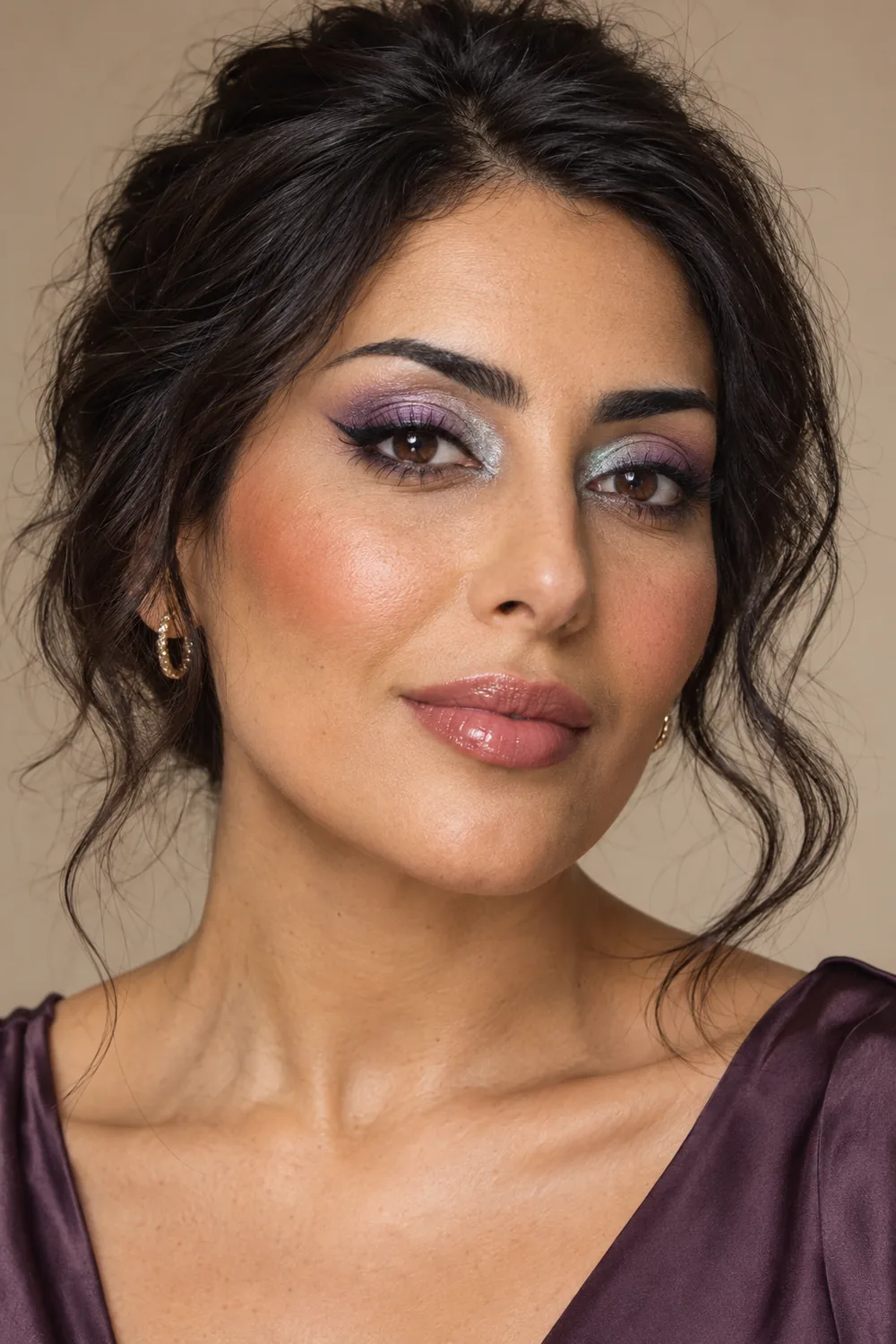 Fictional adult woman with violet eyeshadow, silver inner-corner accents, black winged liner, terracotta blush, and rose gloss.