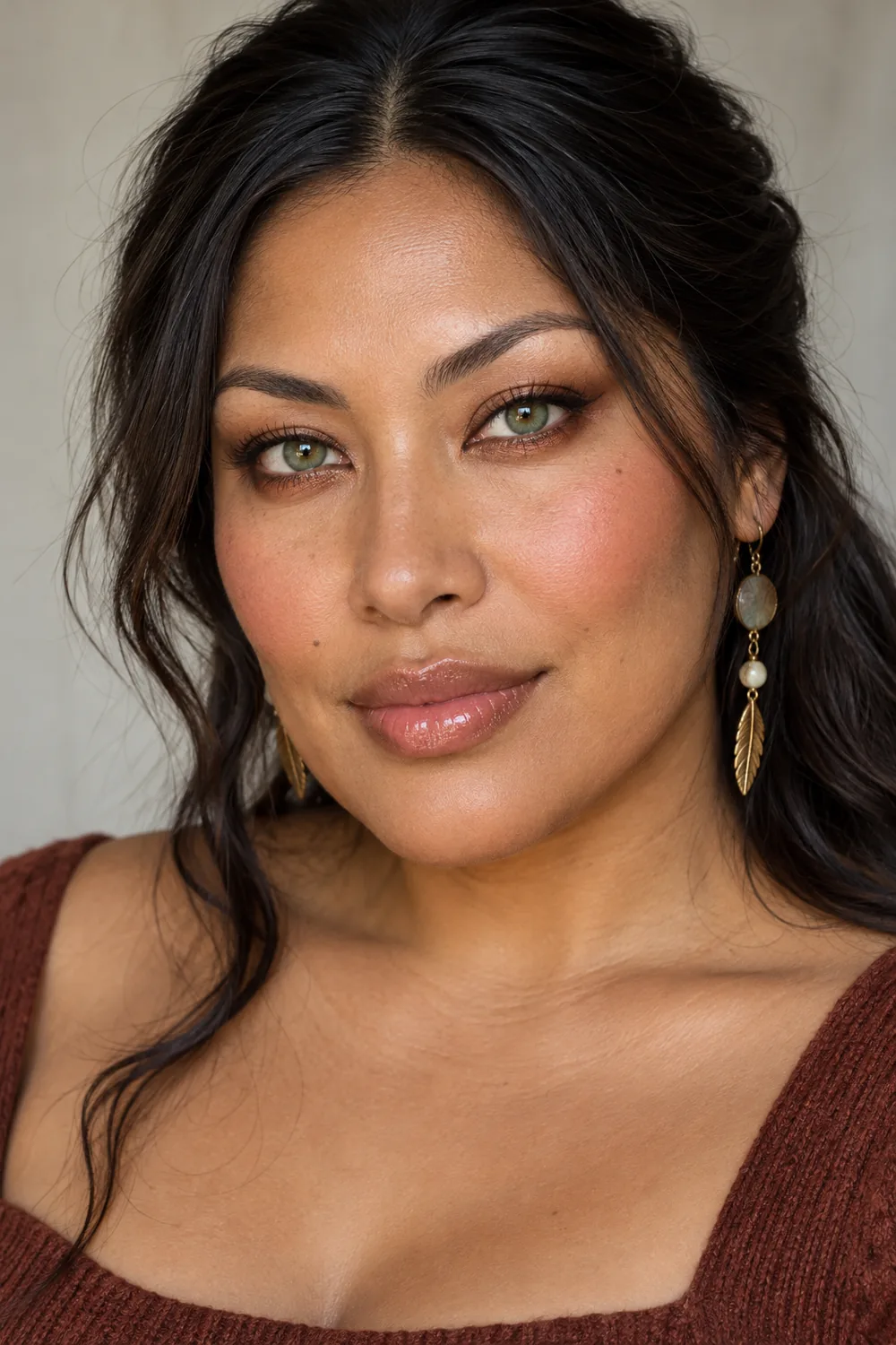 Fictional adult Indigenous North American woman with green irises, bronze lower-lash shadow, sheer neutral lid wash, fine espresso liner, warm rose blush, and glossy caramel-rose lips.